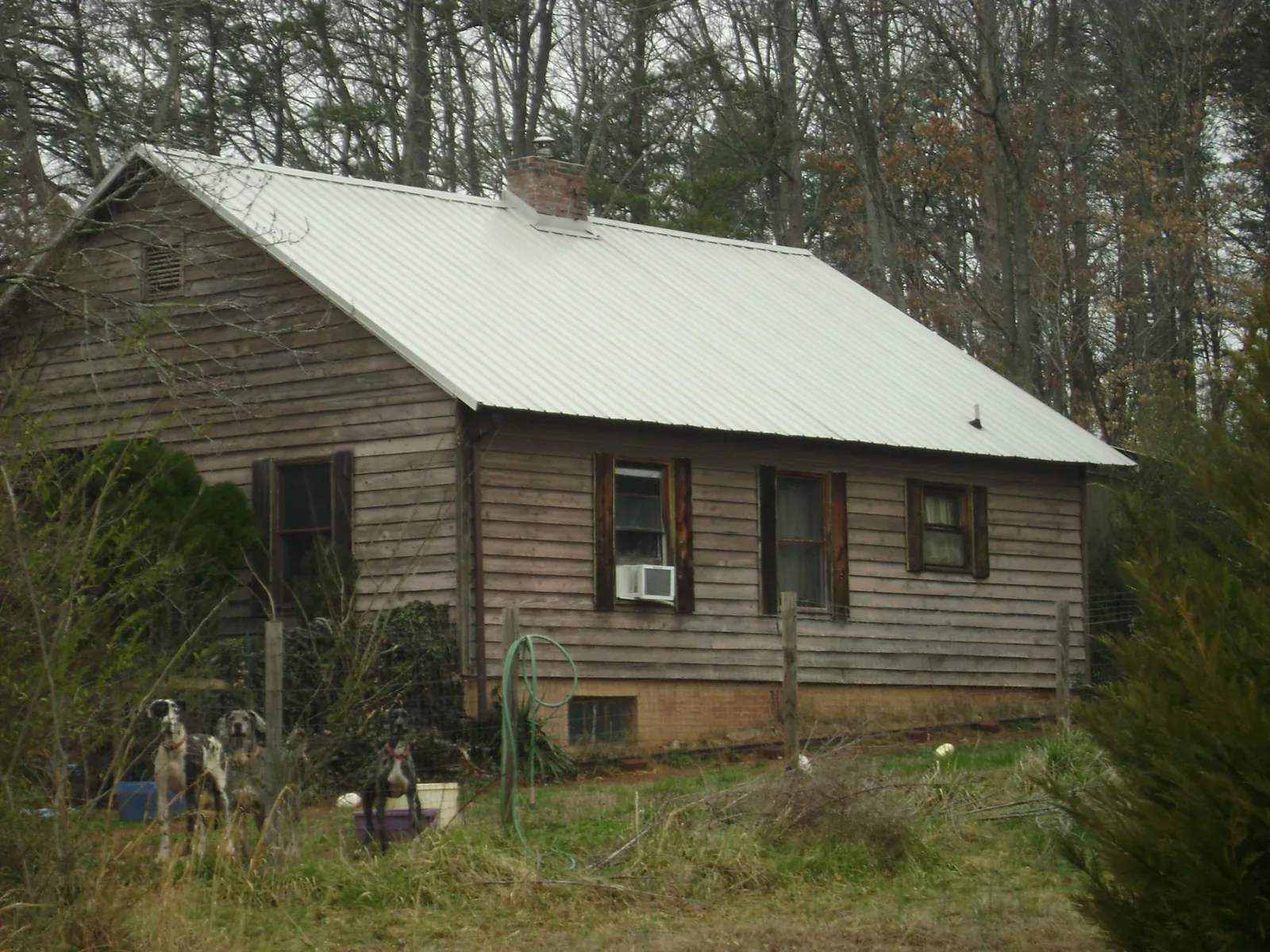 White metal roof on an old wood sided farmhouse, from a Metal Roof Installation job in Battery Park